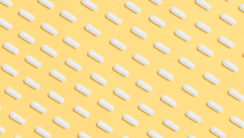 Cost-effective, Health Care Benefits Strategies for Small Businesses A pattern of diagonal lines built from medicine pills against a yellow background.
