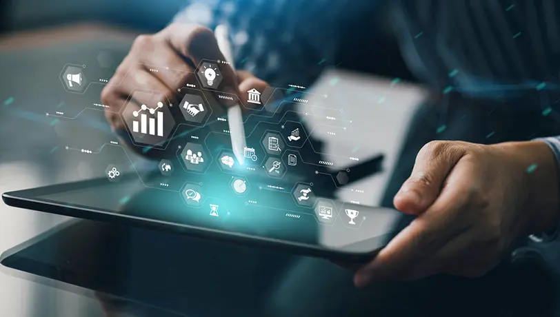A Comprehensive Guide to Marketing Automation for Financial Services Image of a man taping the display of a tablet as it projects a hologram of several types of icons representing Marketing Automation.