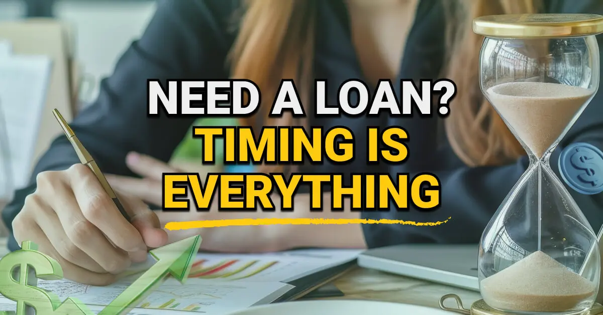 "A woman writing on financial documents beside a sand hourglass, with a green dollar symbol and rising arrow overlay. Text reads: “Need a Loan? Timing Is Everything. "