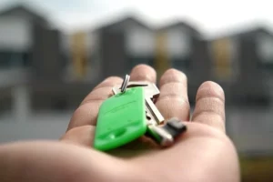 An open hand holding a house key