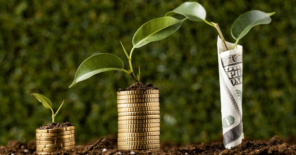 Three stages of plant growth emerging from stacks of coins and paper currency, symbolizing financial growth and investment impact
