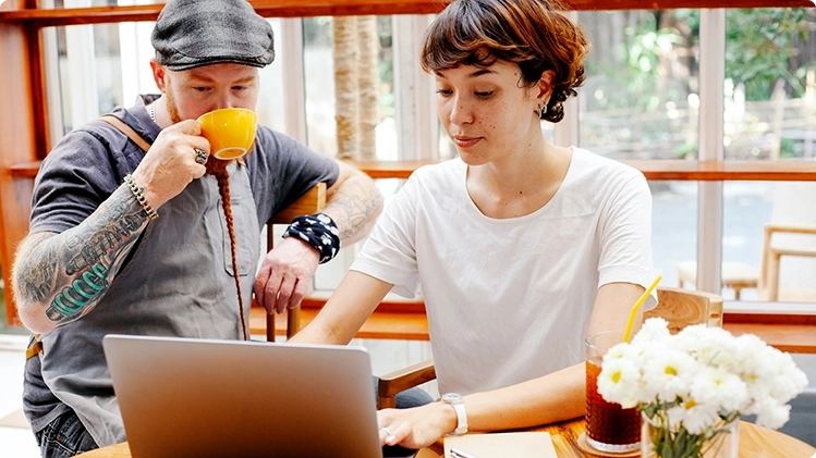 A young couple working with a laptop computer as they are setting a plan for a small business.