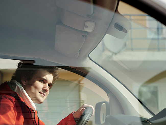A small business driver looking through the windshield as he arrives at his destination.
