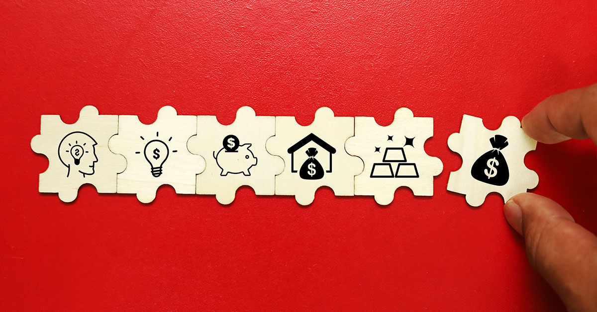 Row of wooden puzzle pieces with financial icons including idea, savings, investment, and money symbols—illustrating the multiple benefits of equipment leasing loans.