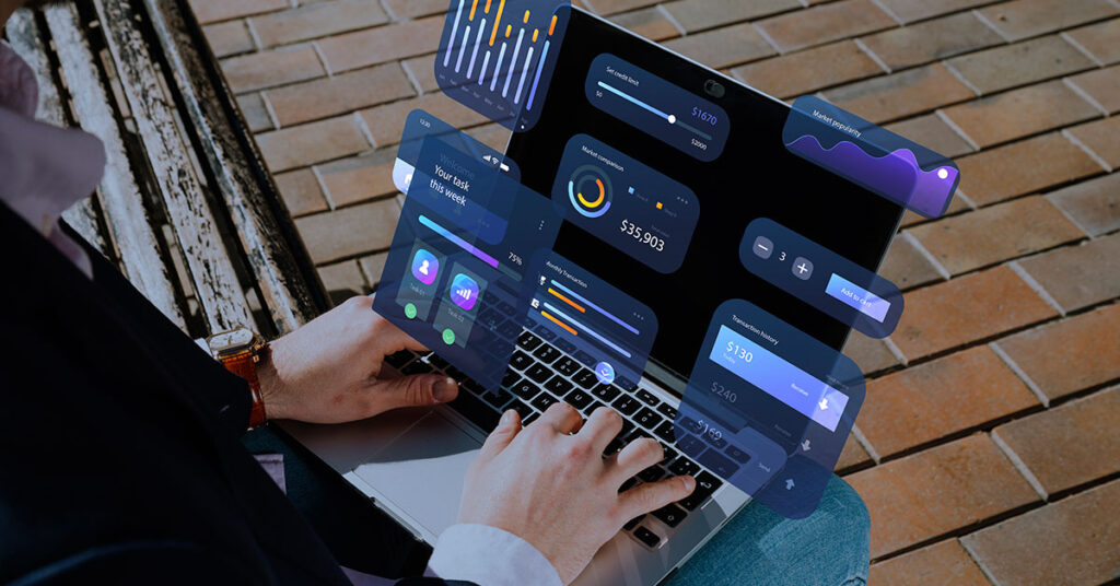 Person using a laptop with virtual financial dashboards and analytics, representing cloud-based accounting software and digital finance management for small businesses.