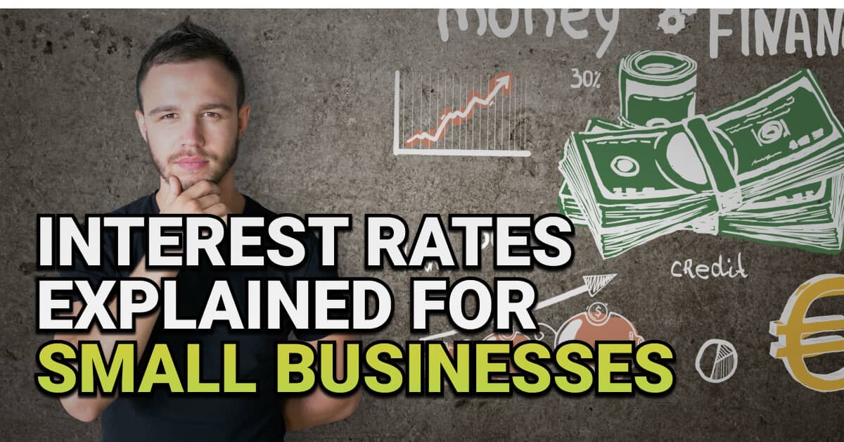 Man standing thoughtfully in front of a chalkboard with hand-drawn financial symbols including stacked money, interest rates, and currency icons. Overlay text reads “Interest Rates Explained for Small Businesses.”